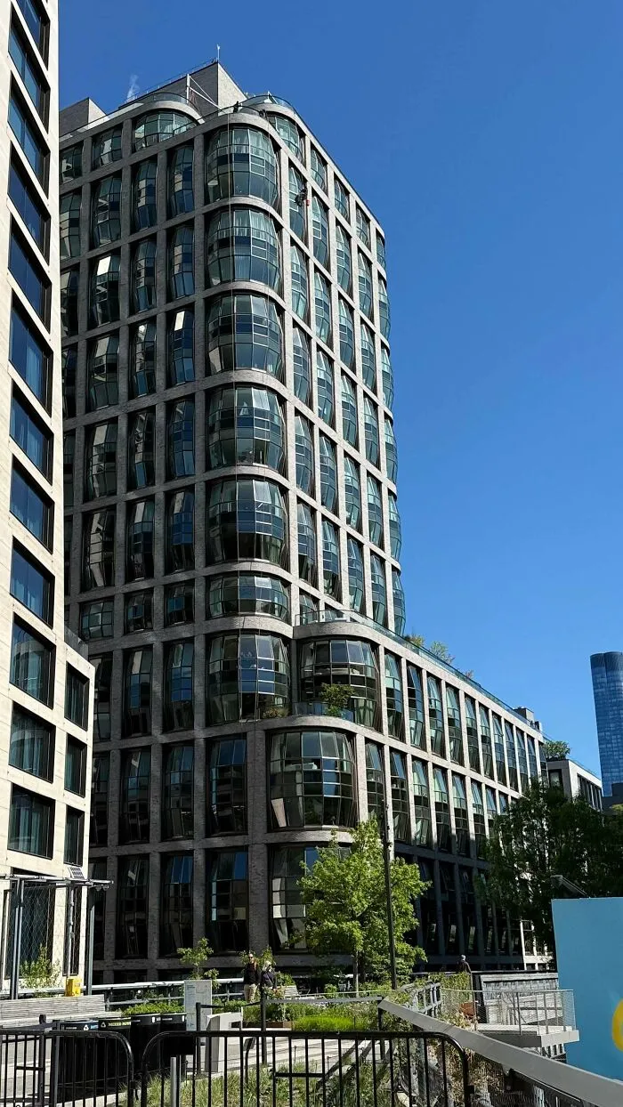 Modern high-rise residential building with curved glass bay windows highlighting contemporary architectural masterpieces
