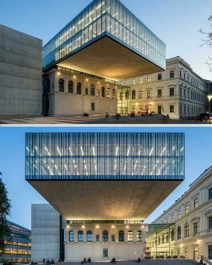 Illuminated modern glass structure over a historical building highlighting innovative architectural masterpieces.