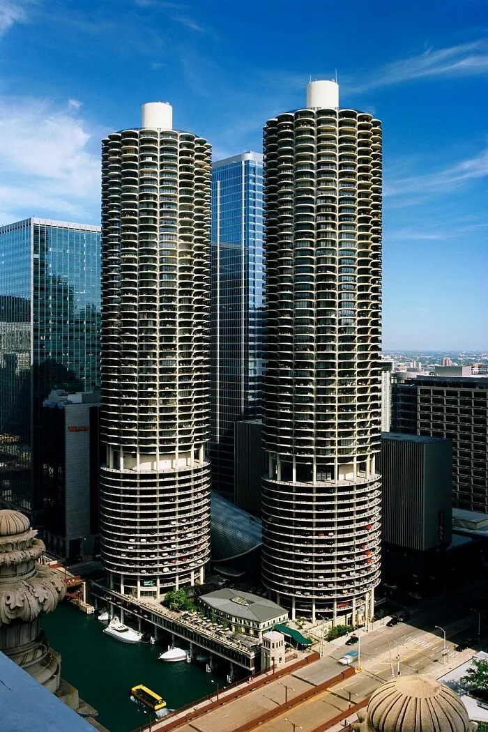 Twin circular high-rise towers along a river demonstrating iconic architectural masterpieces in Chicago