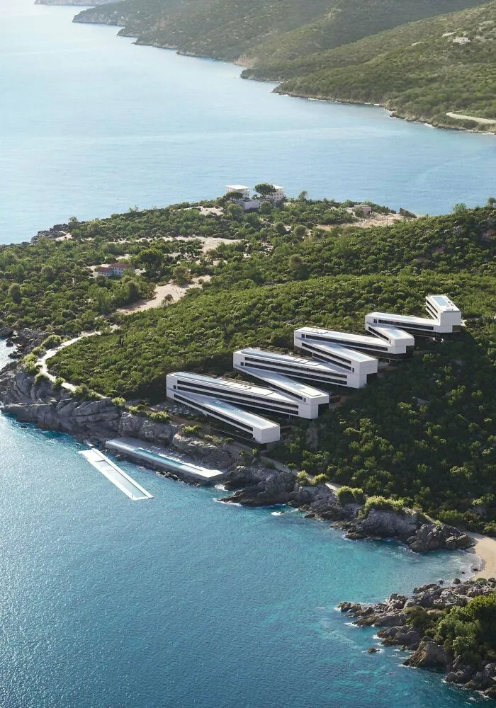 Aerial view of a zigzag coastal resort building highlighting modern architectural masterpieces on a cliffside.
