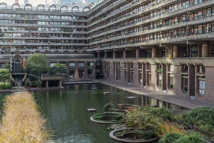 Brutalist residential complex with central water pond featuring architectural masterpieces.