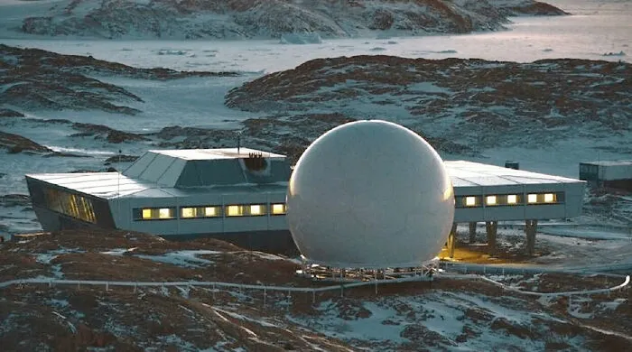 Futuristic research station standing as an architectural masterpiece in a snowy Antarctic landscape.