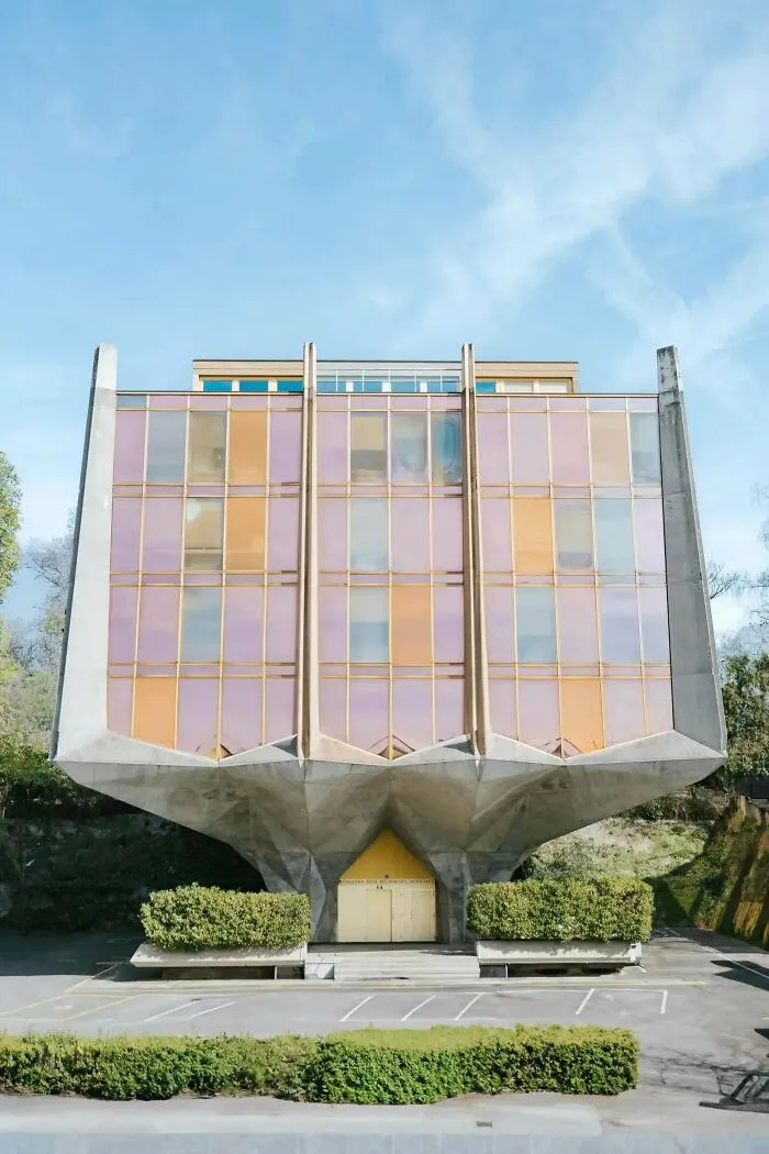 Futuristic concrete building on a narrow pedestal base, an example of bold architectural masterpieces.