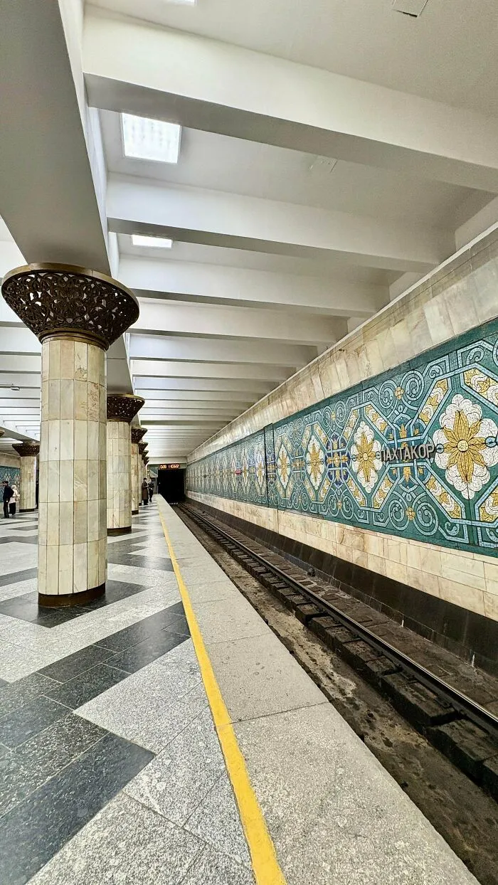 Mosaic decorated subway platform exemplifying stunning architectural masterpieces in public transit design.
