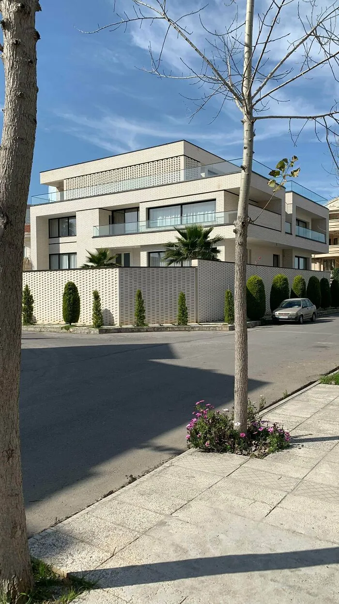 Modern residential building with clean white facade, an architectural masterpiece.
