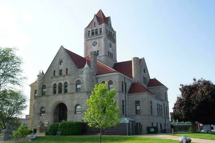 Historic stone clock tower building featuring classic architectural masterpiece details.