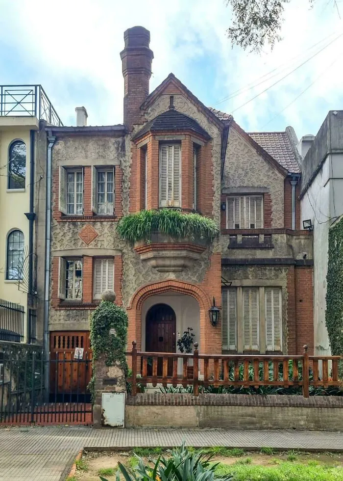 Charming brick house with unique windows, an example of residential architectural masterpieces