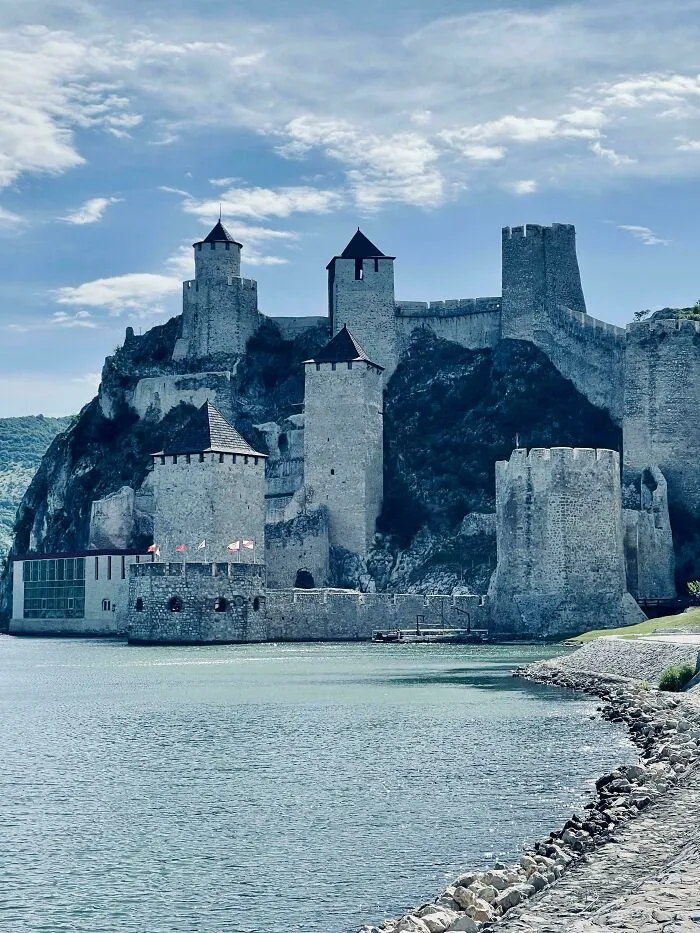 Historic stone fortress on a waterfront, showcasing architectural masterpieces.