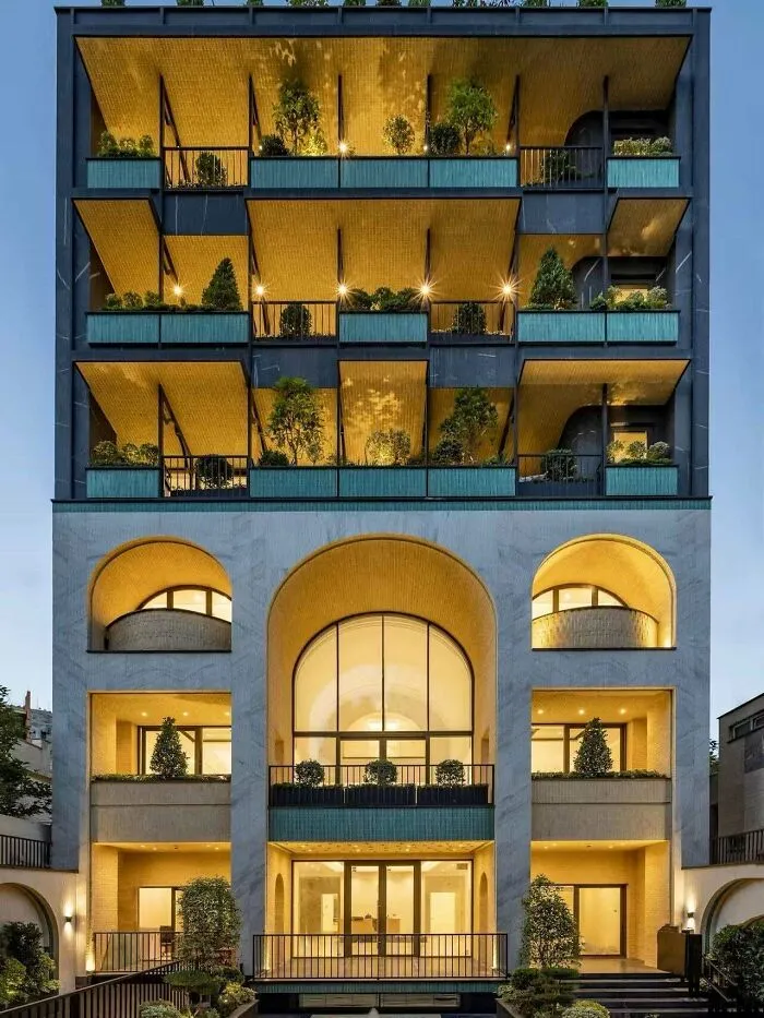 Modern apartment building with glowing balconies, showcasing architectural masterpieces.