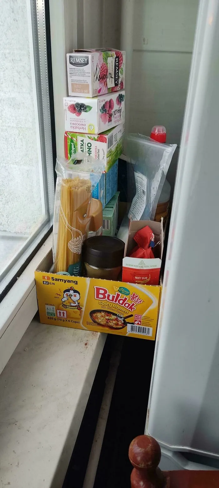 Pantry items stored inside a cardboard box show smart frugal tips for organizing