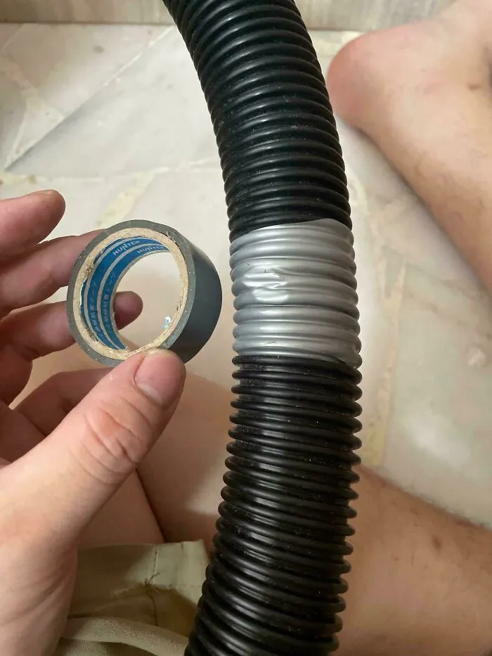 A person holding duct tape used to fix a flexible hose as part of frugal tips