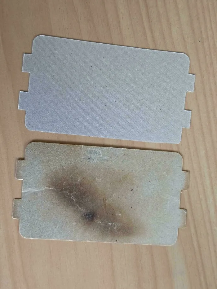 A fresh microwave mica sheet replacement next to a burnt one as part of frugal tips