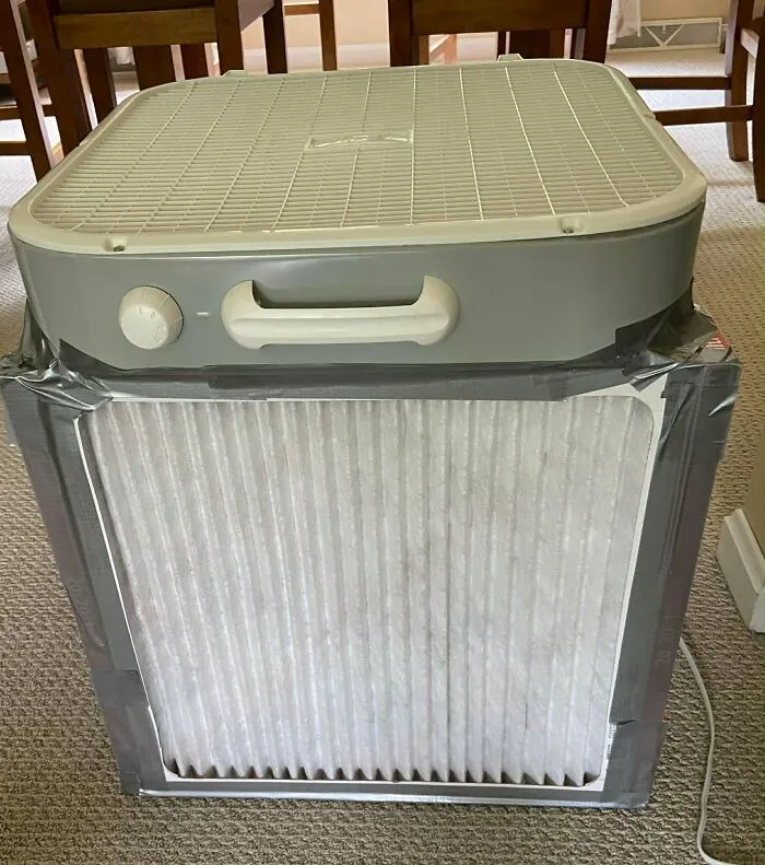 A homemade air purifier made with a box fan and furnace filter showing practical frugal tips.
