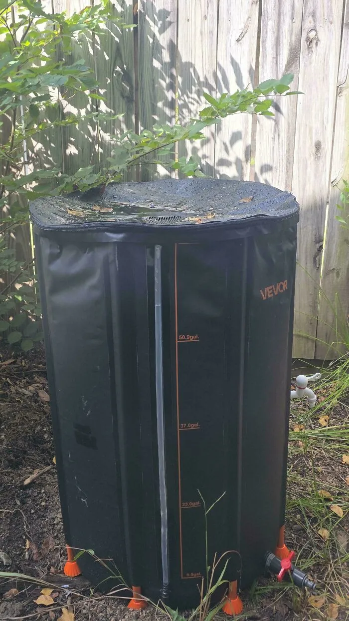 A black outdoor water collector tank, highlighting frugal tips for saving on utility bills