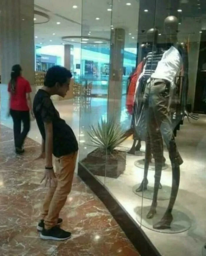 Funny memes showing a man imitating a mannequin with an unusually curved posture inside a shopping mall.