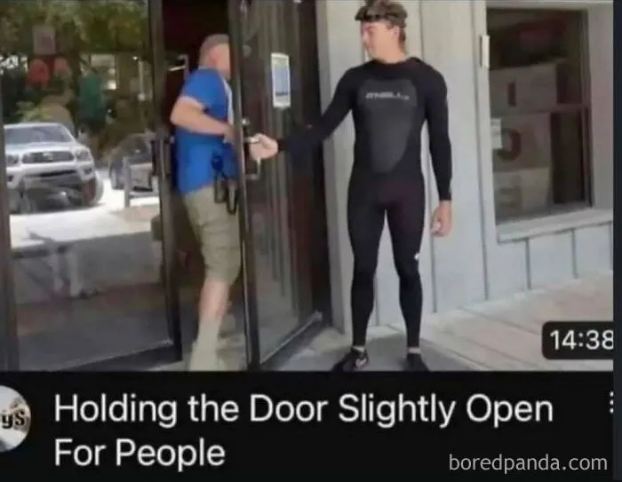 A man in a wetsuit holding a glass door open slightly, featured in funny memes.