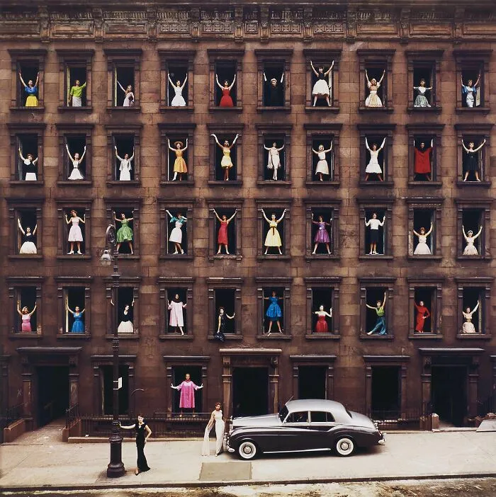 Real pictures of models in colorful dresses standing in windows of a brown building