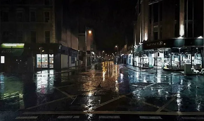Real pictures of a wet city street at night looking like an oil painting due to rain reflections