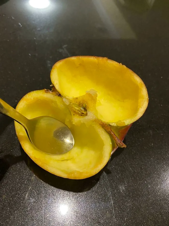 An apple hollowed out with a spoon, showing husbands funniest quirks.