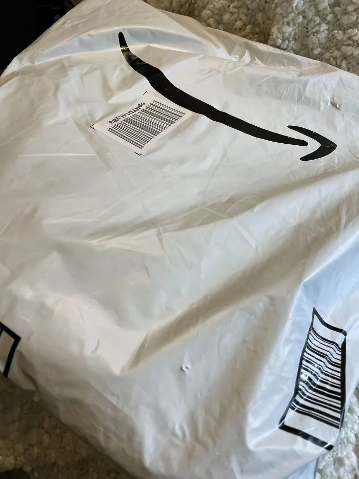 An Amazon package on the floor, showcasing the audacity of some men who ordered items using someone else's account