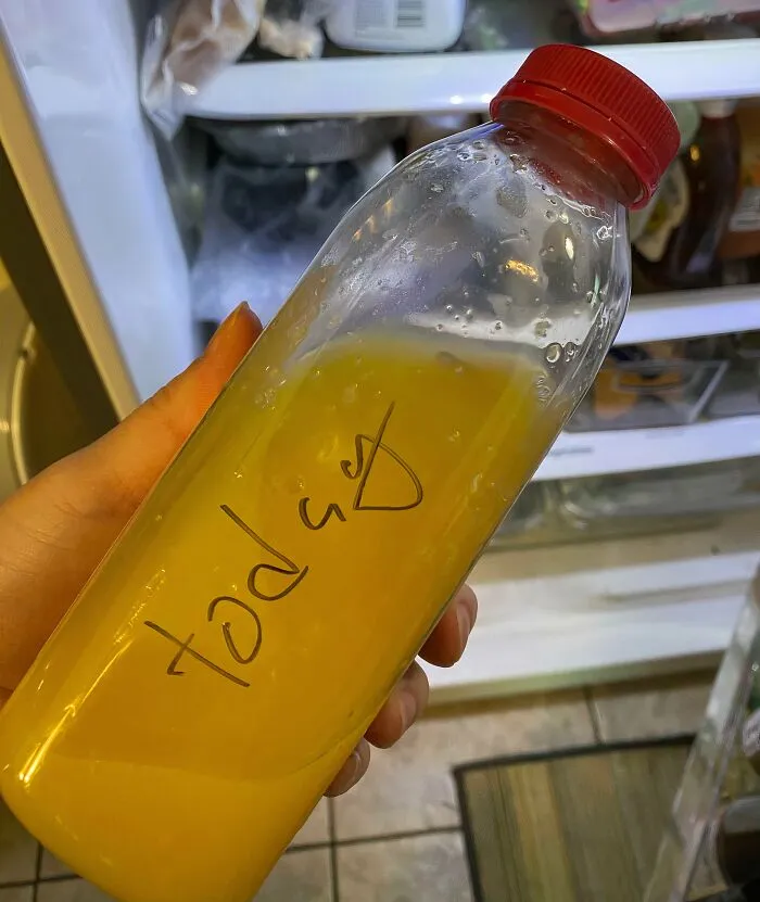 An orange juice bottle with the word today handwritten on it, showing the audacity of some men in the kitchen.