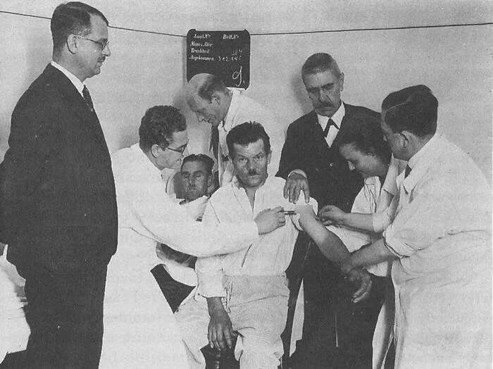A group of historical medical professionals treating a patient in a vintage clinic
