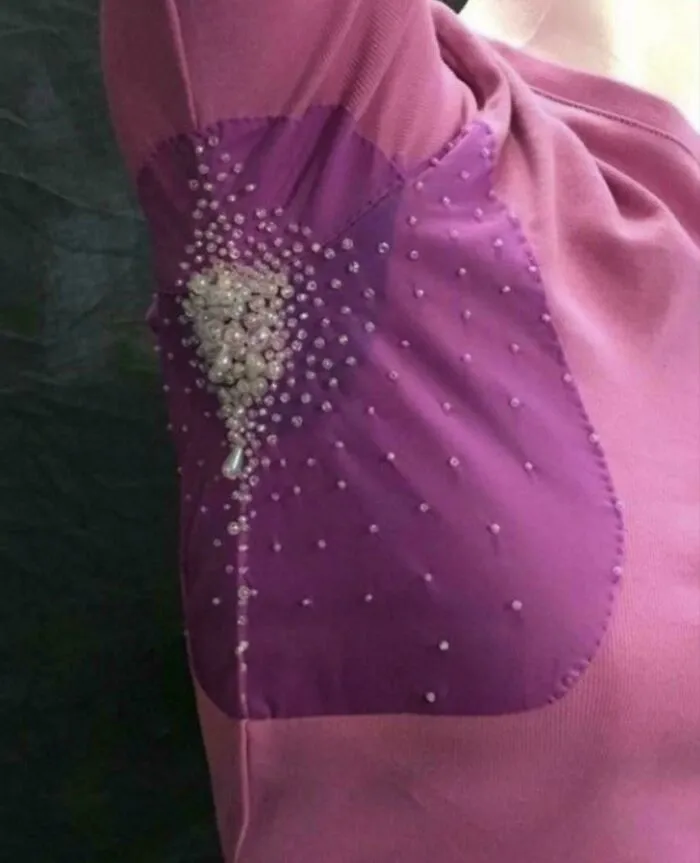 A pink shirt featuring beaded armpit sweat patches as awful creations.