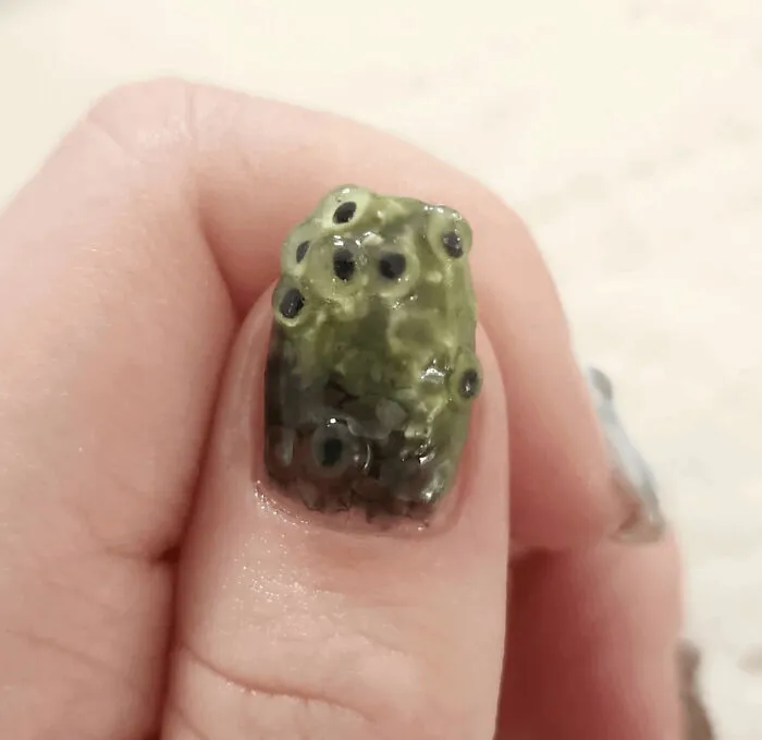 Gross nail art featuring a frog spawn design, part of awful creations.