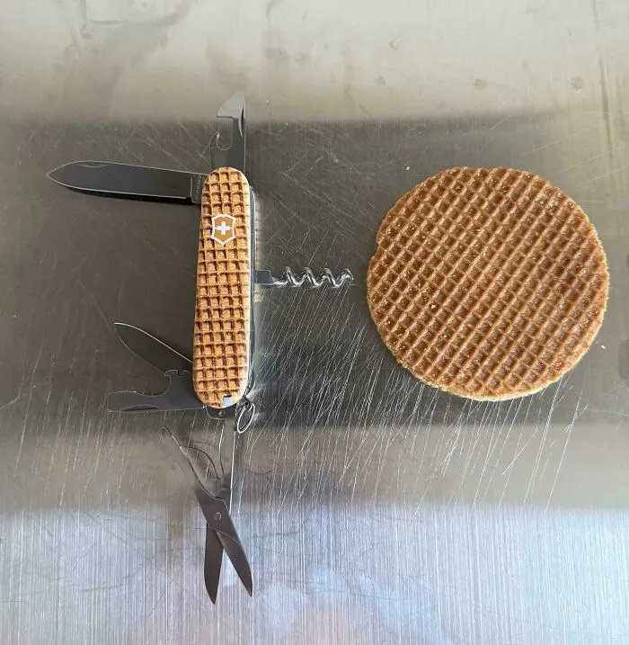 A pocket knife creation styled like a stroopwafel next to a real waffle cookie.