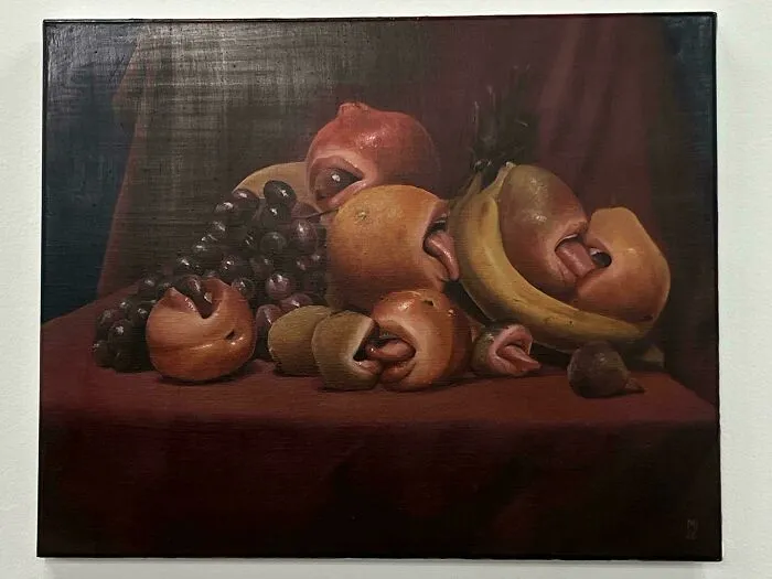 Still life painting of fruits with mouths and tongues, an awful creation far too well-made to ignore.