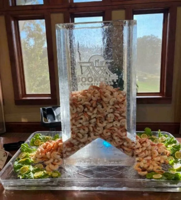 Large ice sculpture filled with fresh shrimp displayed at an event, part of creations awful to look at.
