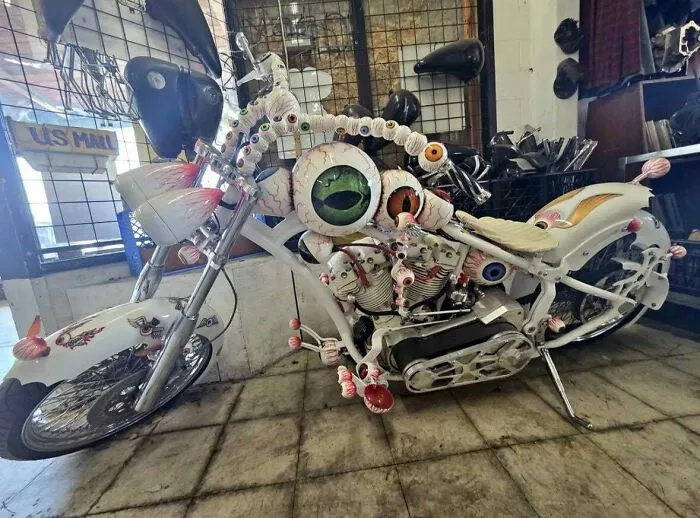 A custom motorcycle covered in realistic eyeball decorations as well-made creations.