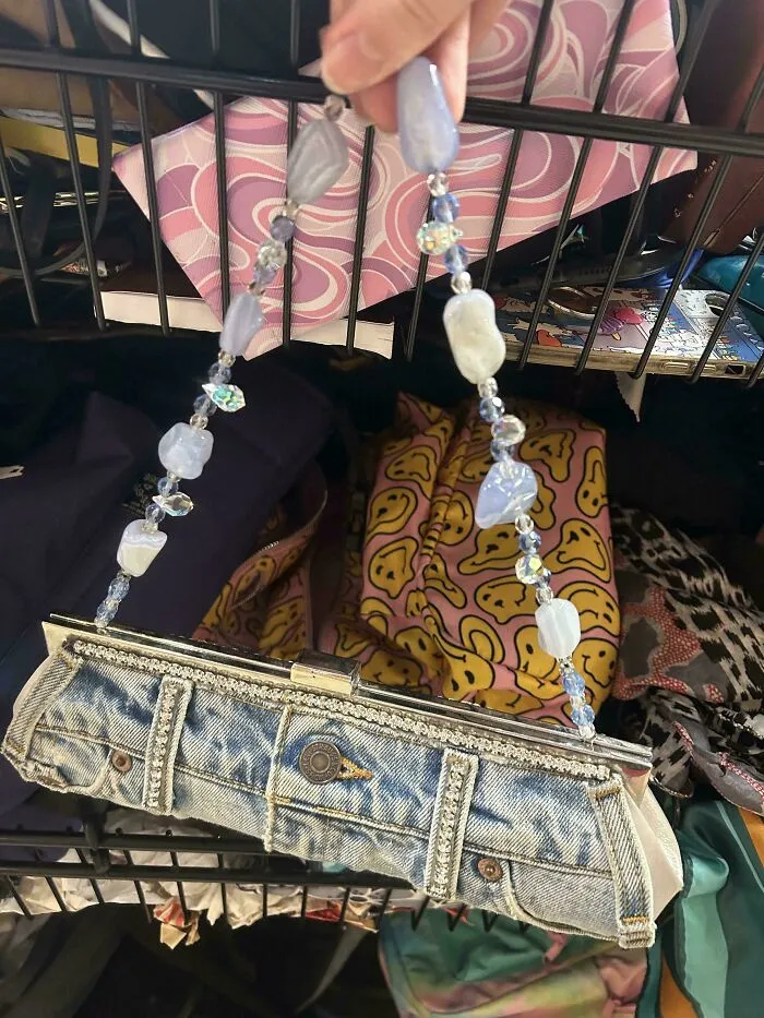 A handbag made from denim jeans with a beaded handle, depicting unique creations.