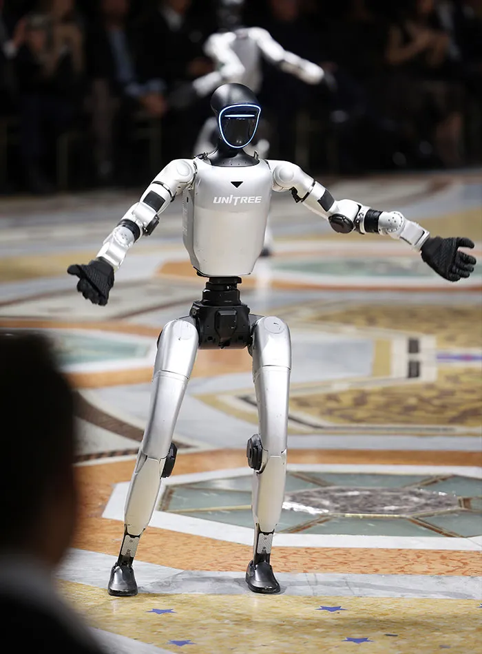 Robot performing on stage at Plastic Surgery Expo event
