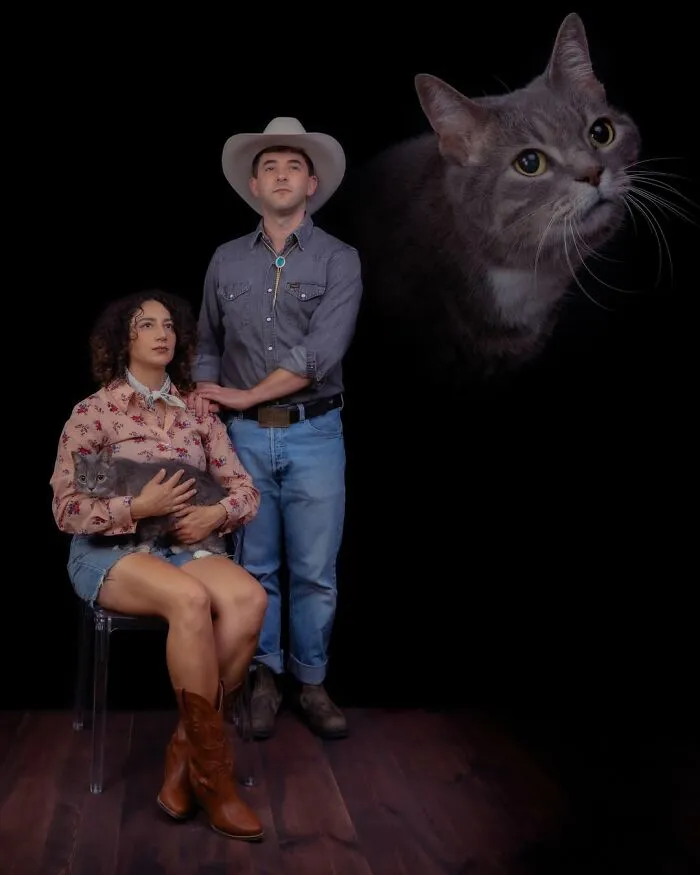 A silly portrait of pets and their owners featuring a couple in cowboy attire holding a grey cat, with a large cat head floating above them.