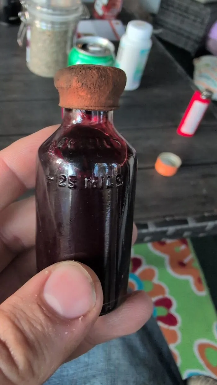 Hand holding a vintage medicine bottle from medical history