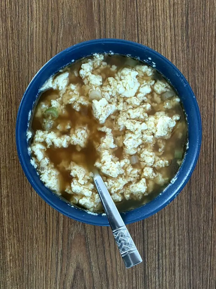 Crumbled tofu in a dark savory broth, a bizarre example of unusual food combinations.