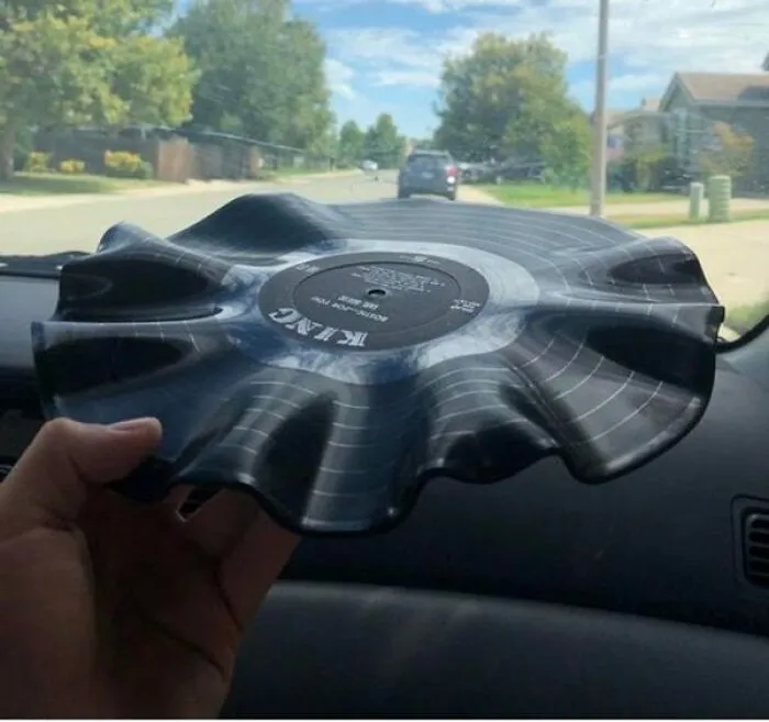 Interesting and cool photos of a vinyl record warped and melted by heat inside a car