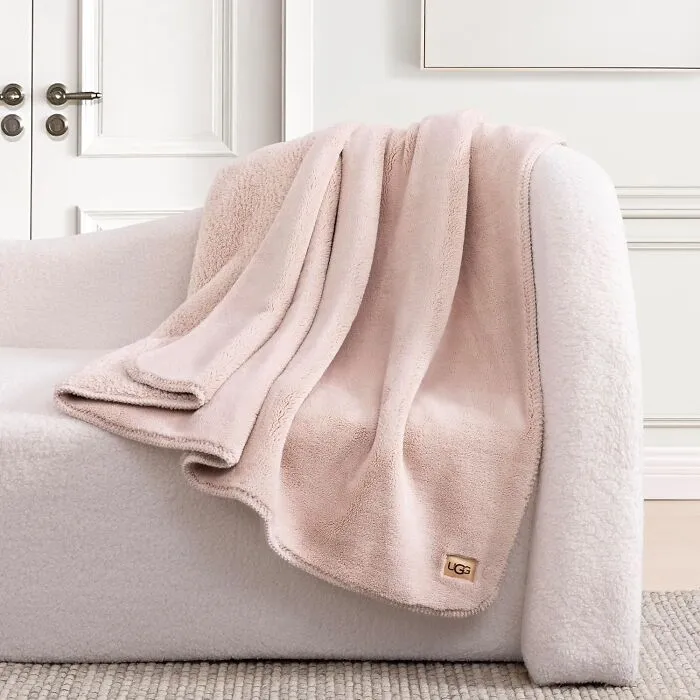 Soft UGG blanket draped over a cozy chair, a top pick from Prime Big Deal Days.