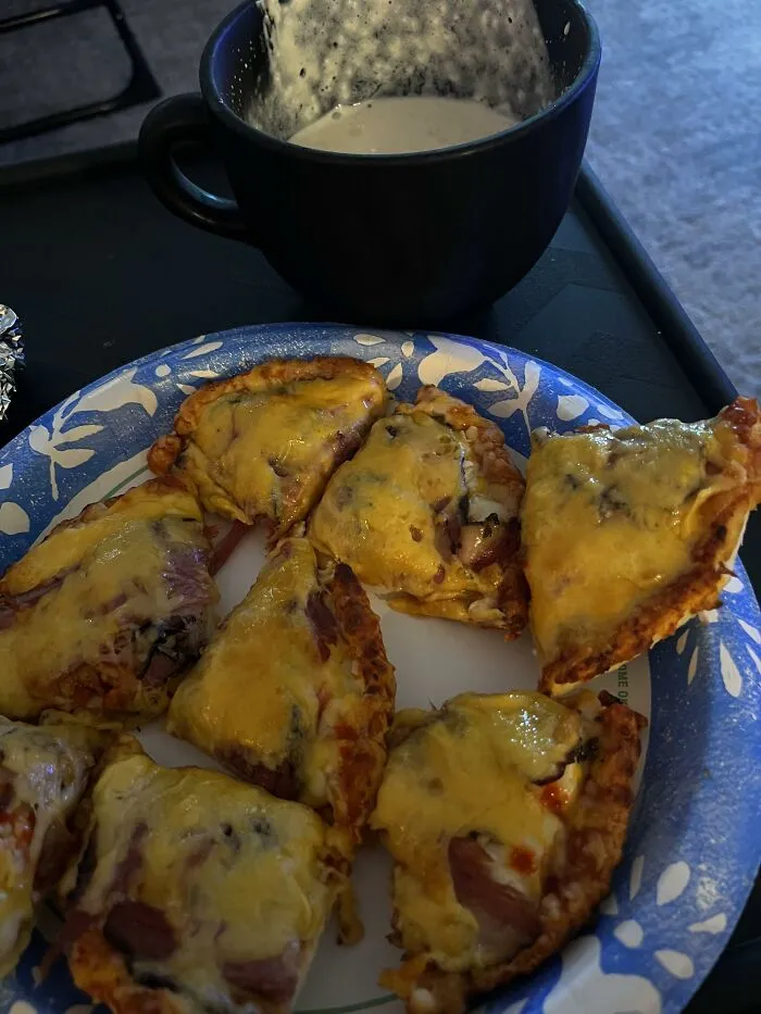 Slices of quesadilla or pizza next to a dark mug, featuring unique food combinations