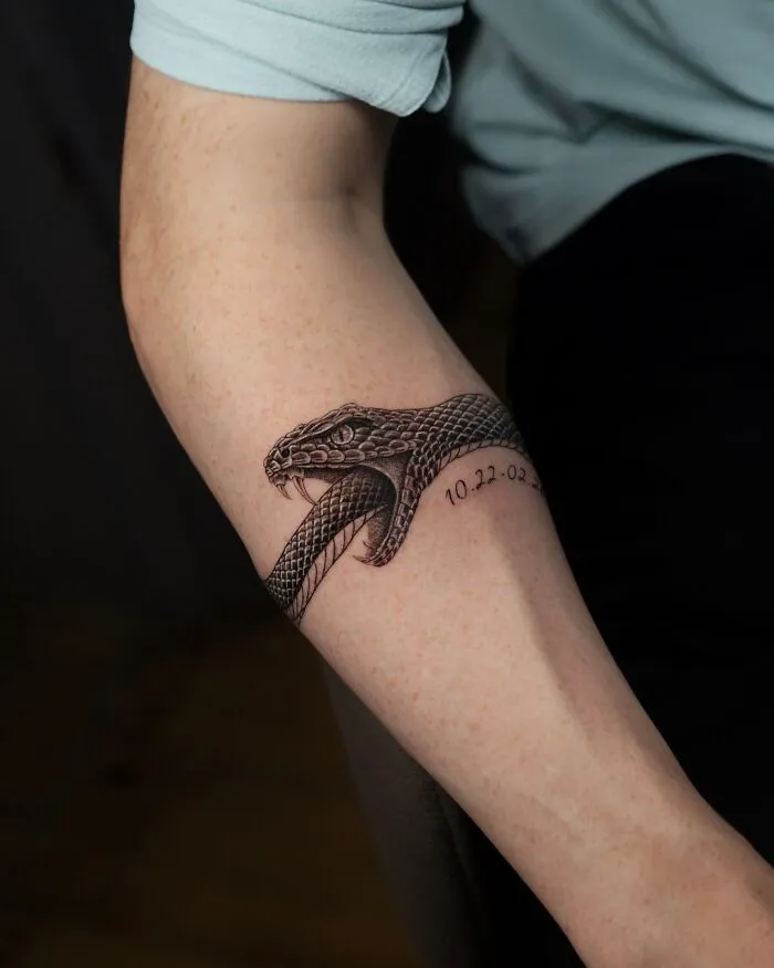 Snake tattoo with detailed scales nature ink on forearm