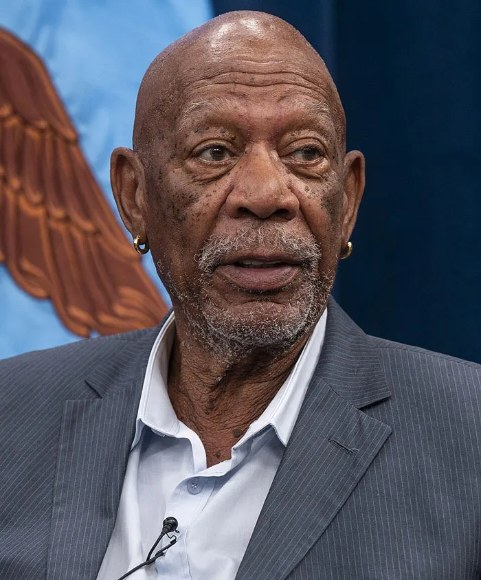 Morgan Freeman speaking at an event, a famous face revealing Hollywood secrets.
