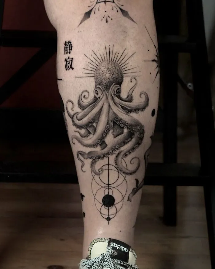 Black ink octopus tattoo with geometric designs on calf
