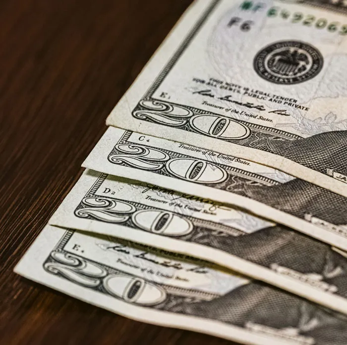 Close-up of US twenty dollar bills, symbolizing financial aspects that can lead to relationships and headaches.