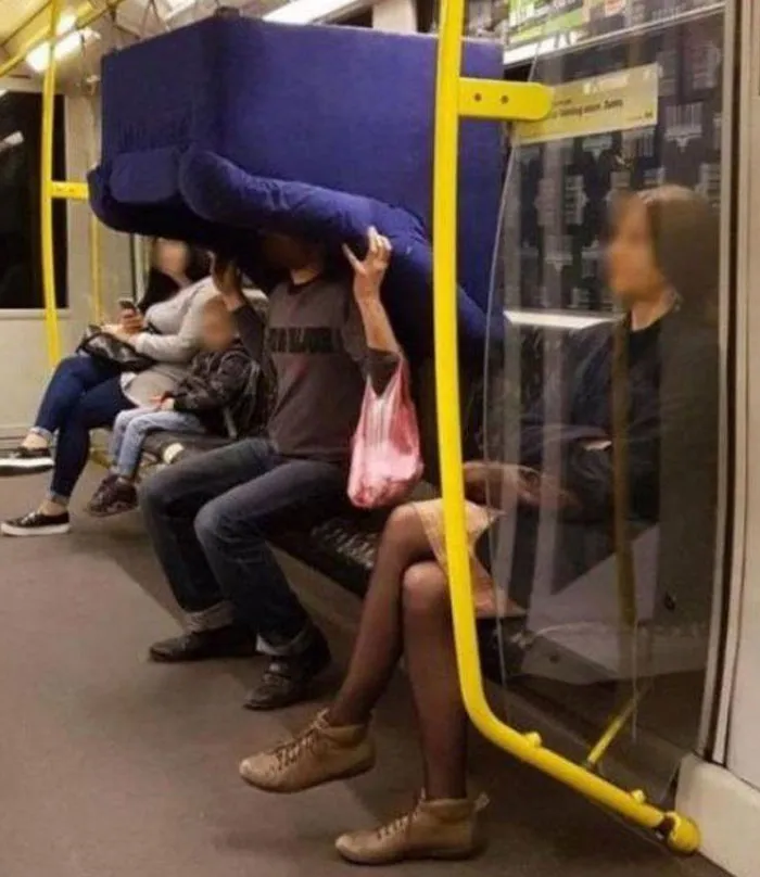 Man carrying large couch on subway seat causes moving fails