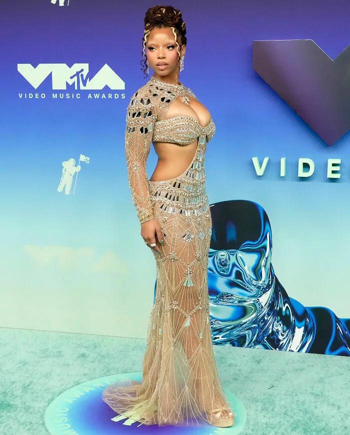Celebrity in beaded sheer gown at 22 VMAs red carpet event