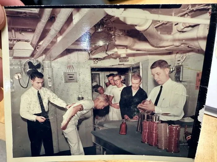 Vintage photograph of navy sailors in a submarine lab highlighting an era in medical history.