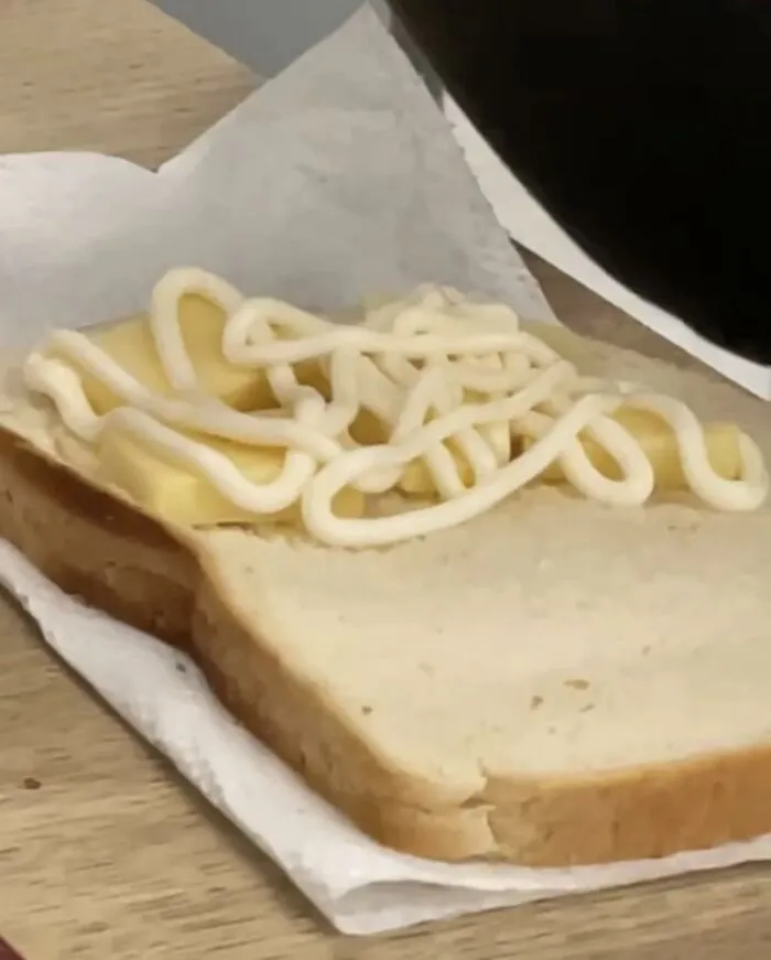 Strange food combinations with cheese slice and mayonnaise on bread