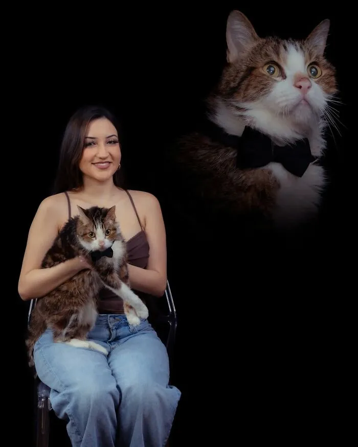 A woman holding her pet cat wearing a bow tie, with a portrait of the cat floating above on a black background, creating quirky portraits of pets and their owners.