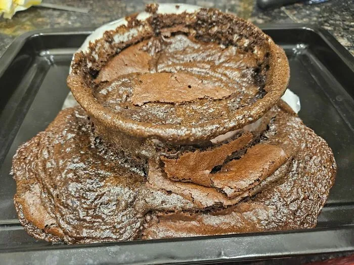 Failed chocolate cake disastrously spilling from pan cooking fail